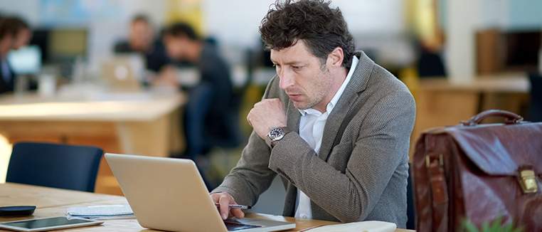 Een zakenman achter zijn computer in een modern kantoor